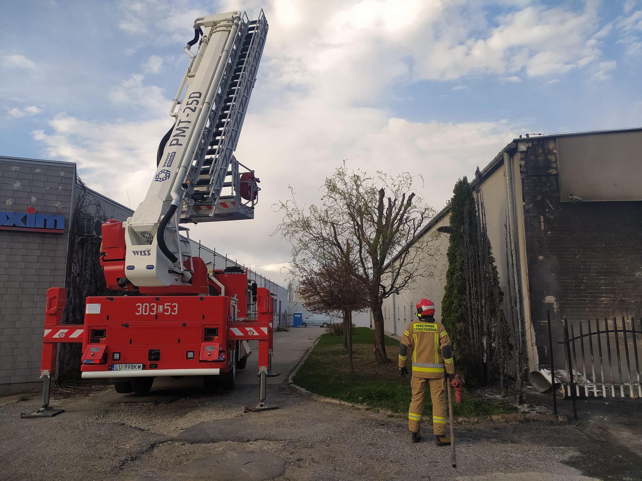 Strażak oraz wóz strażacki na miejscu pożaru
