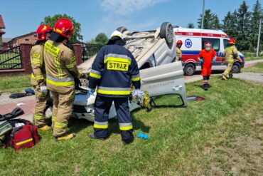 Strażacy zabezpieczający samochód, który uległ wypadkowi w Wojcieszynie